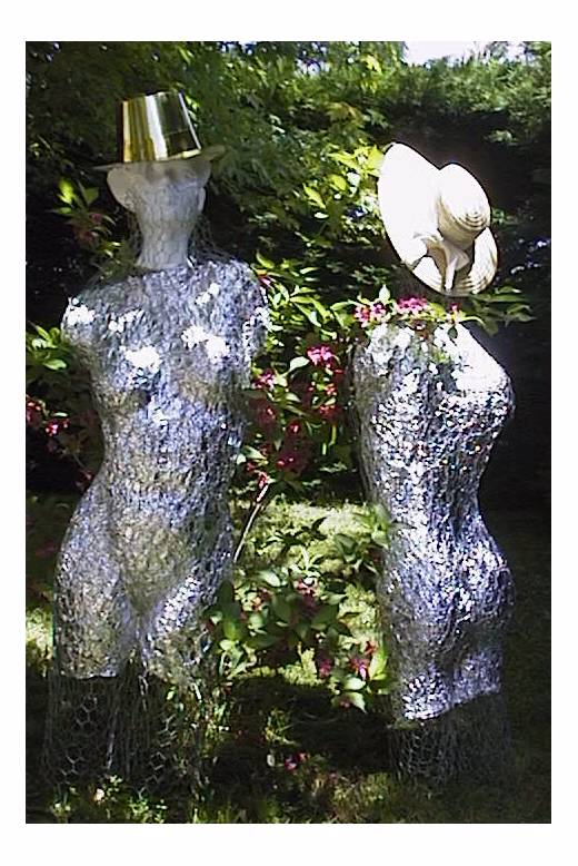 The Ladies — two woven wire torsos in the garden